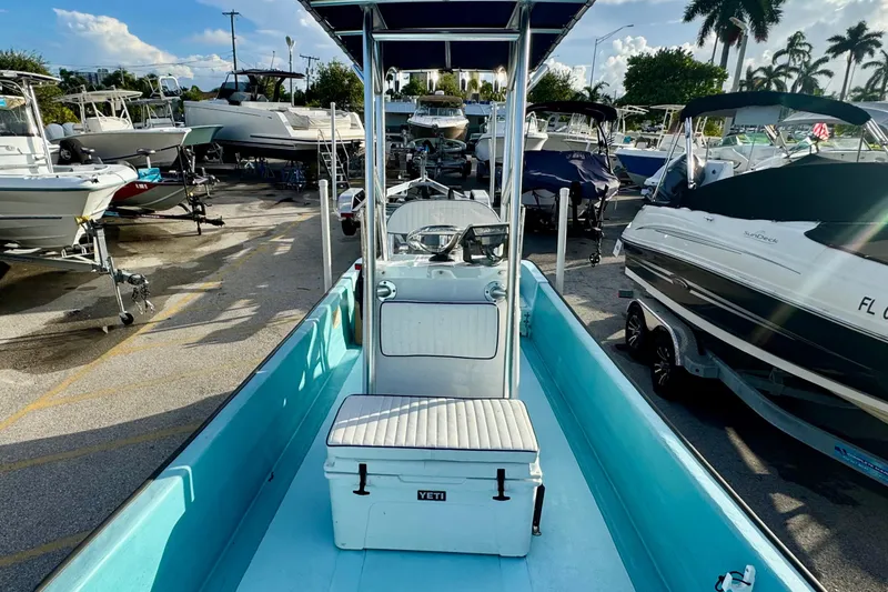 Slide: The Image of 2024 Panga 25 CC boat in marina, surrounded by other vessels under a sunny sky. - 17