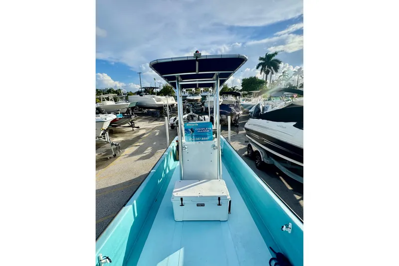 Slide: The Image of 2024 Panga 25 CC boat with blue interior, docked among other boats. - 18