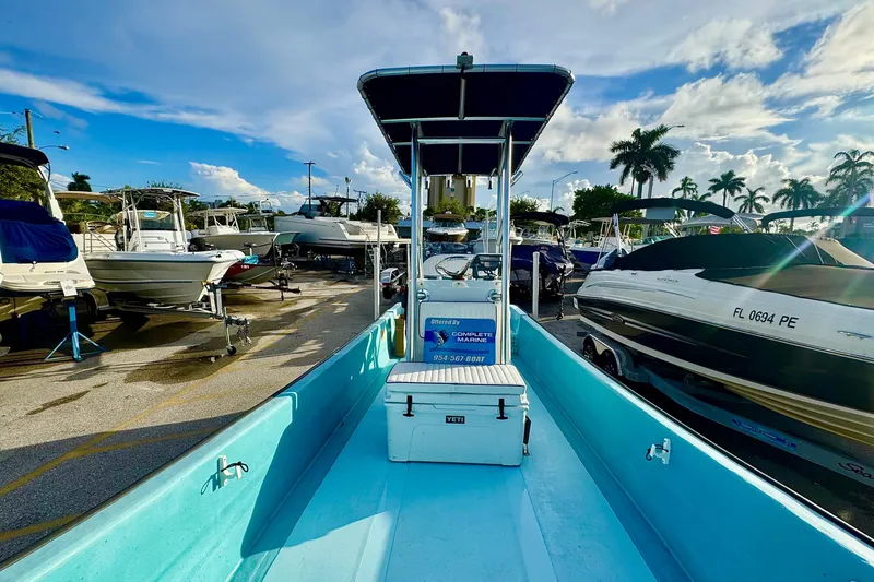 Slide: The Image of 2024 Panga 25 CC boat in marina, surrounded by other boats under a blue sky. - 23