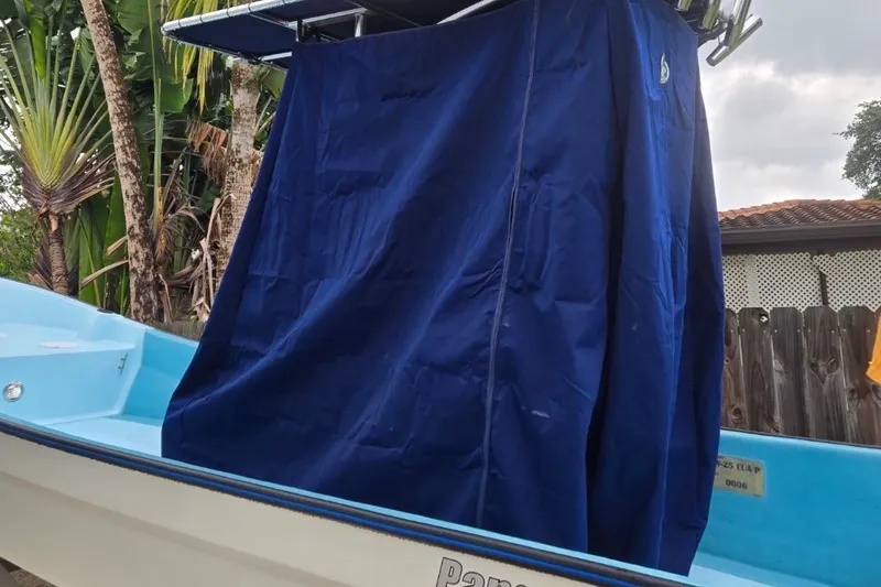 Slide: The Image of 2024 Panga IMEMSA 25 CC boat with blue cover, tropical background. - 24