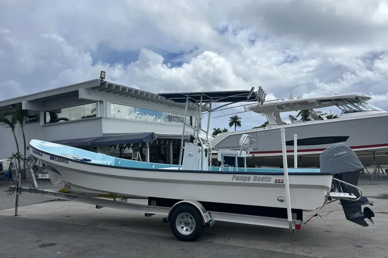 Slide: The Image of 2024 Panga IMEMSA 25 CC boat on trailer, parked outside dealership under cloudy sky. - 25