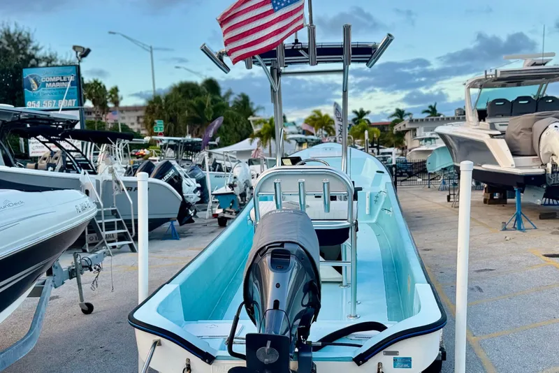 Slide: The Image of 2024 Panga 25 CC boat with American flag, displayed at a marina. - 29