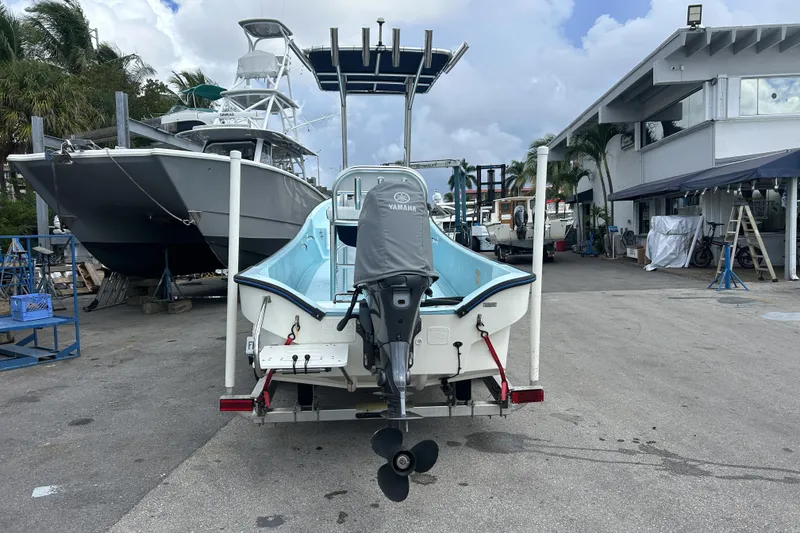 Slide: The Image of 2024 Panga IMEMSA 25 CC boat with Yamaha motor in a marina setting. - 3