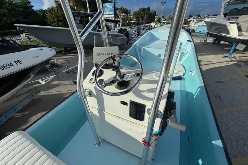 Slide: The Image of 2024 Panga 25 CC boat with Garmin navigation, showcased at a marina. - 34