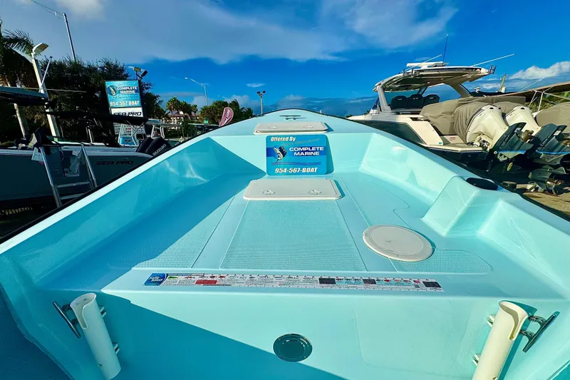 Slide: The Image of 2024 Panga 25 CC boat displayed at a marina under a clear blue sky. - 36