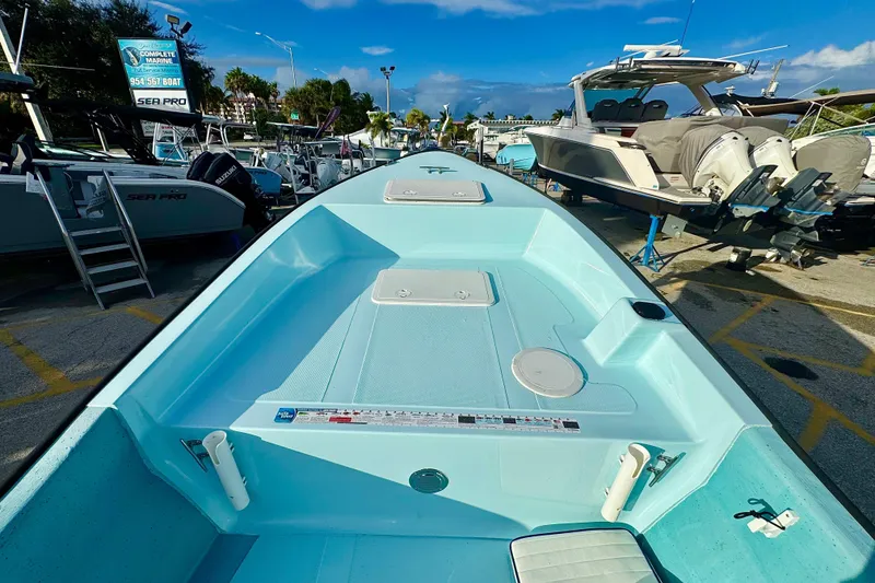 Slide: The Image of 2024 Panga 25 CC boat in a marina, showcasing spacious deck and sleek design. - 37