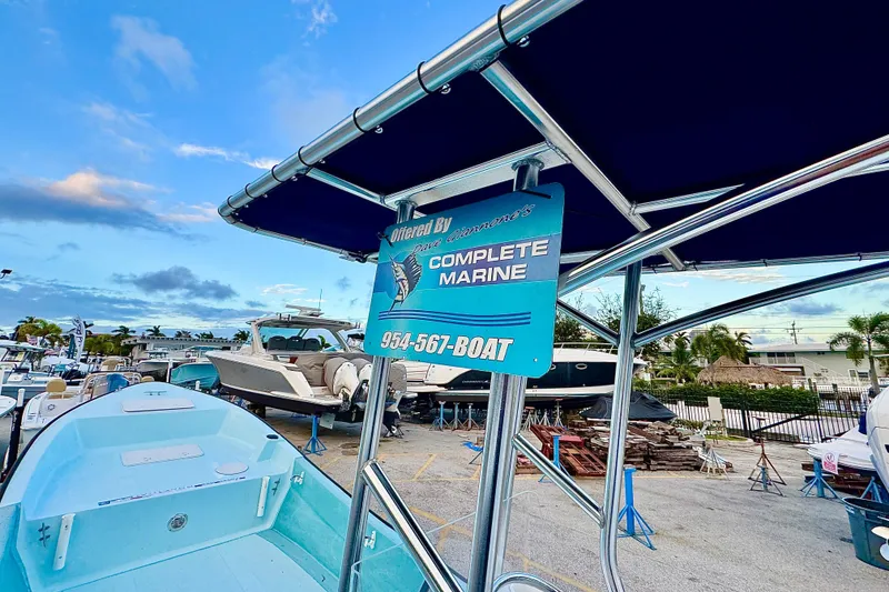 Slide: The Image of 2024 Panga 25 CC boat displayed at a marina with a blue canopy. - 41