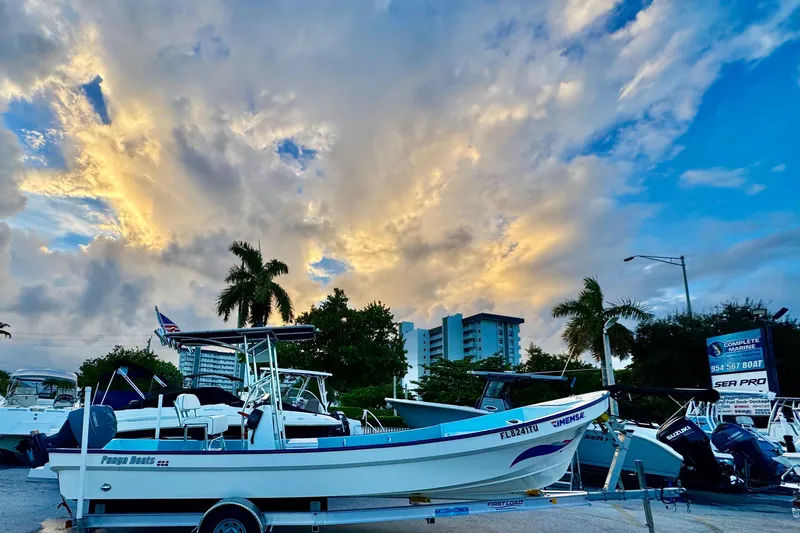 Slide: The Image of 2024 Panga 25 CC boat on trailer under dramatic sunset sky. - 42