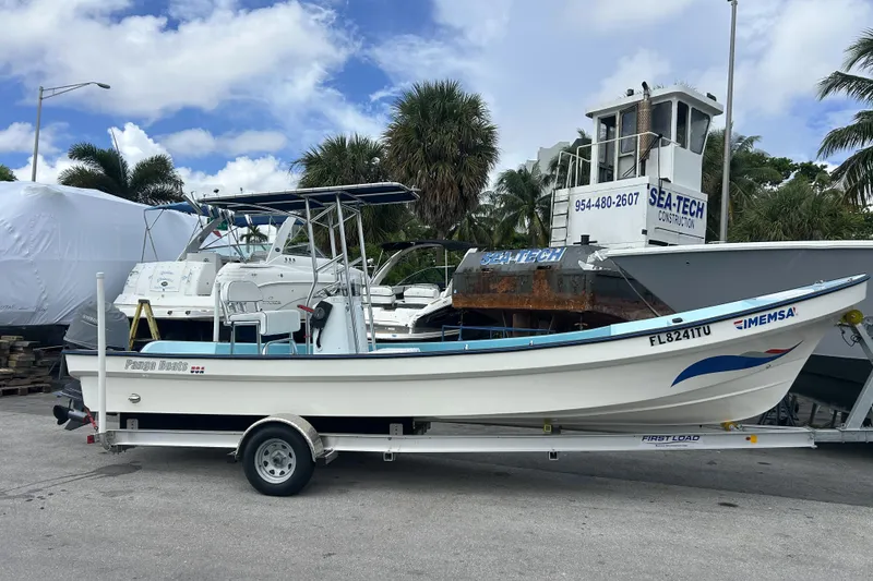 Slide: The Image of 2024 Panga IMEMSA 25 CC boat on trailer, parked outdoors with palm trees in background. - 48