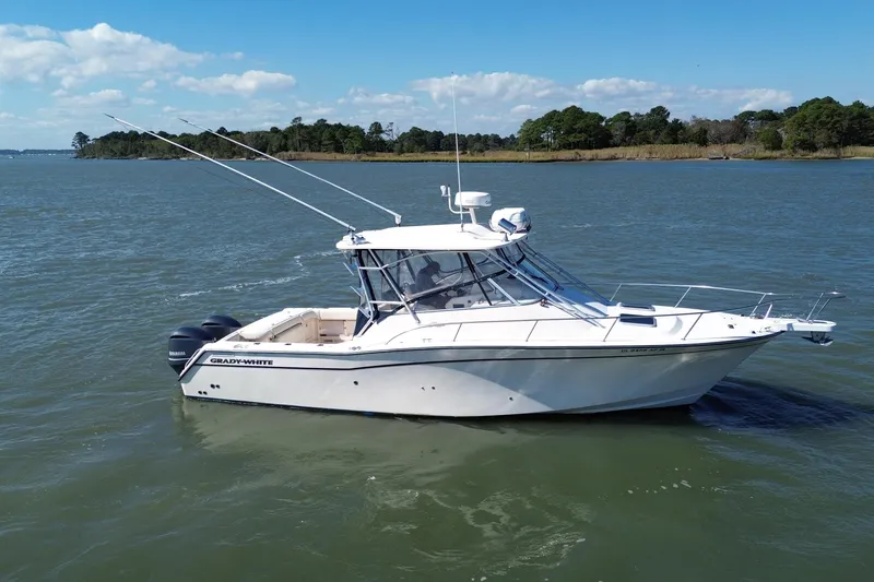 Slide: The Image of 2005 Grady-White Express 330 boat on calm water, clear sky background. - 1
