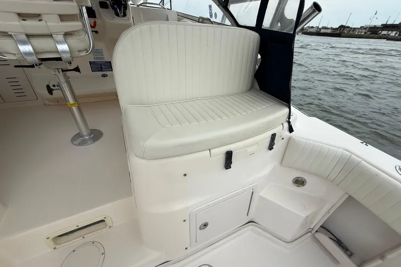 Slide: The Image of 2005 Grady-White Express 330 boat interior with cushioned seating by the water. - 11