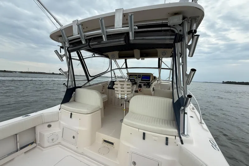 Slide: The Image of 2005 Grady-White Express 330 boat interior with seating and controls on open water. - 12