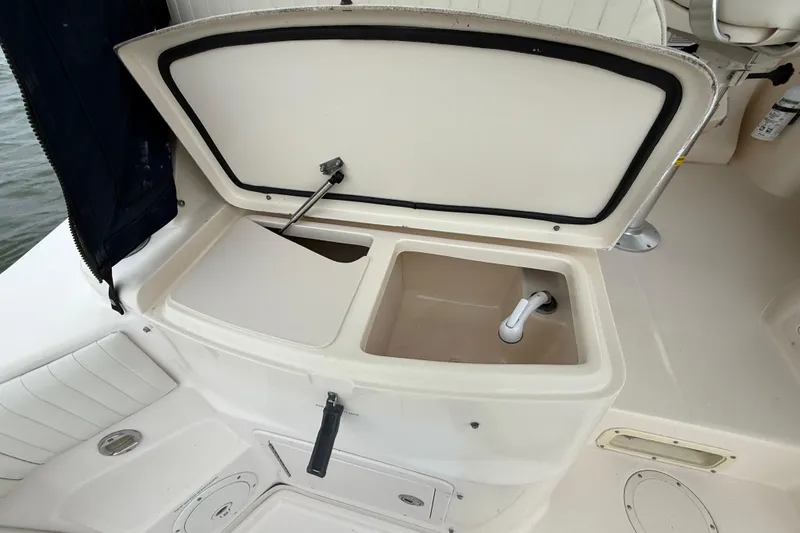 Slide: The Image of 2005 Grady-White Express 330 boat sink and storage compartment open. - 13