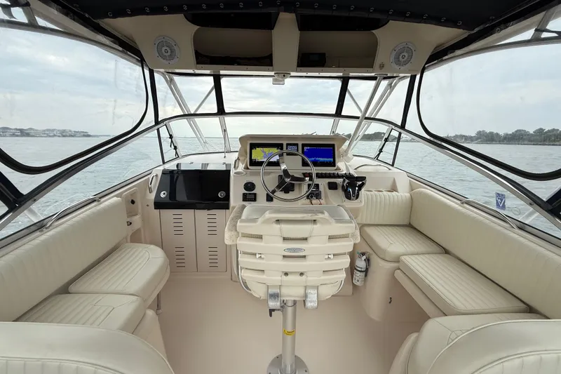 Slide: The Image of 2005 Grady-White Express 330 boat interior with steering console and seating. - 15