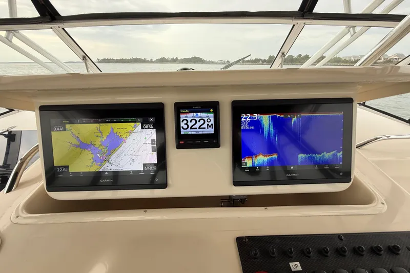Slide: The Image of Dashboard of a 2005 Grady-White Express 330 with Garmin navigation displays. - 19