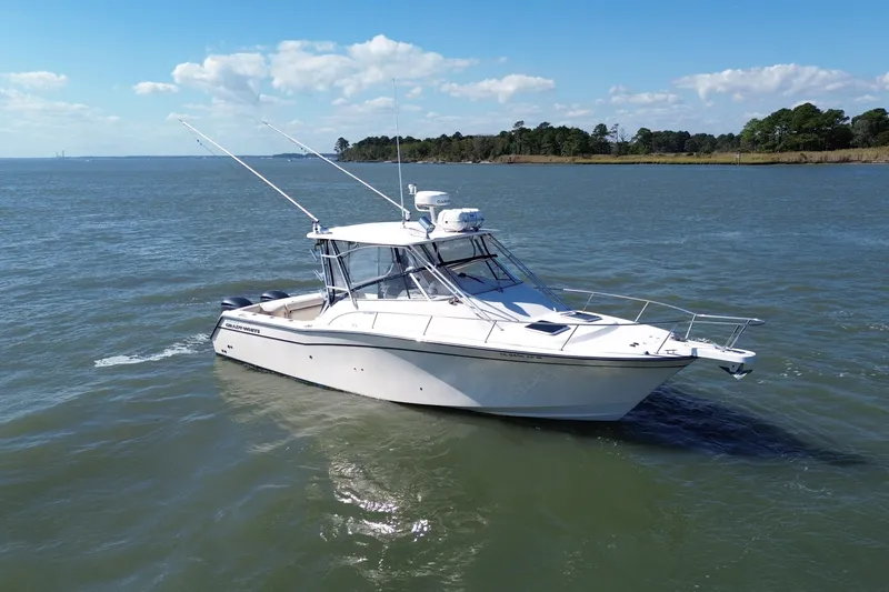 Slide: The Image of 2005 Grady-White Express 330 boat on calm water under a clear blue sky. - 2