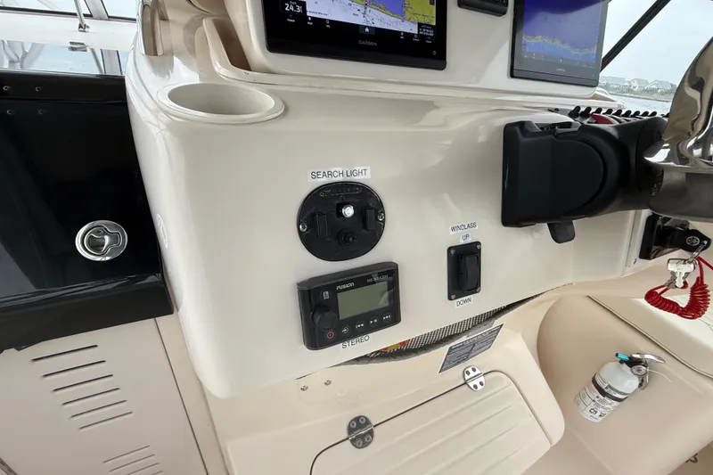 Slide: The Image of 2005 Grady-White Express 330 boat dashboard with navigation and control instruments. - 20