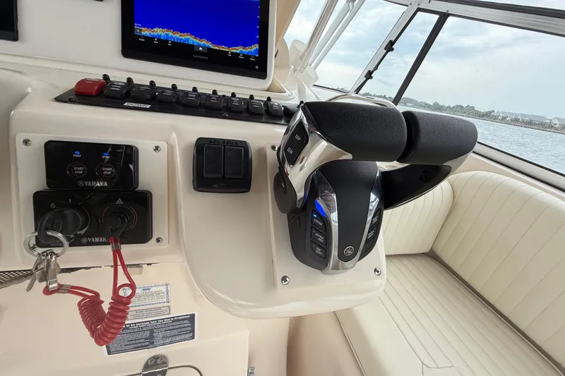 Slide: The Image of 2005 Grady-White Express 330 boat cockpit with Yamaha controls and Garmin display. - 21