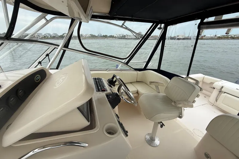 Slide: The Image of 2005 Grady-White Express 330 boat interior with helm and seating, overlooking marina. - 22