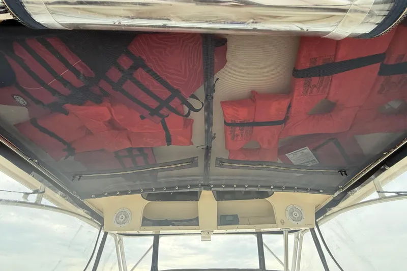 Slide: The Image of Interior view of 2005 Grady-White Express 330 boat with red life jackets stored overhead. - 26