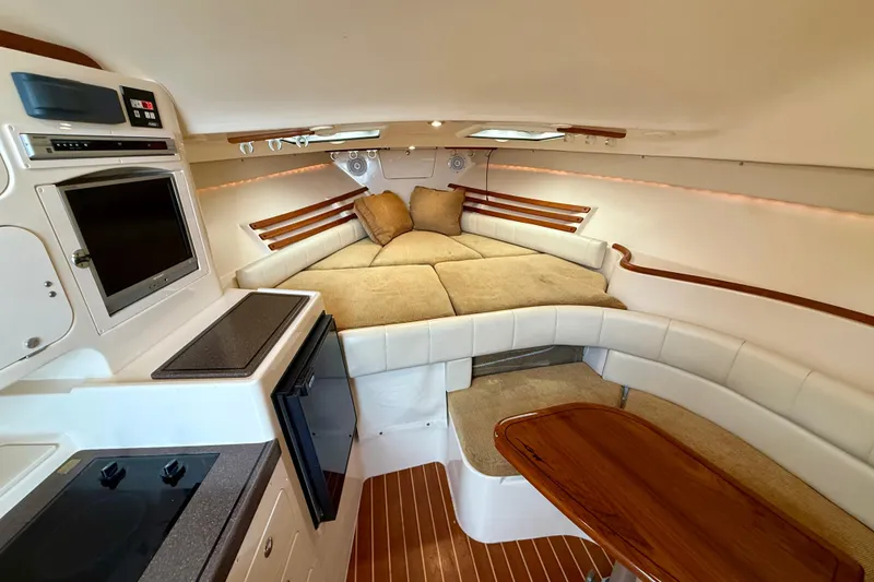 Slide: The Image of 2005 Grady-White Express 330 cabin interior with cozy seating and kitchenette. - 27