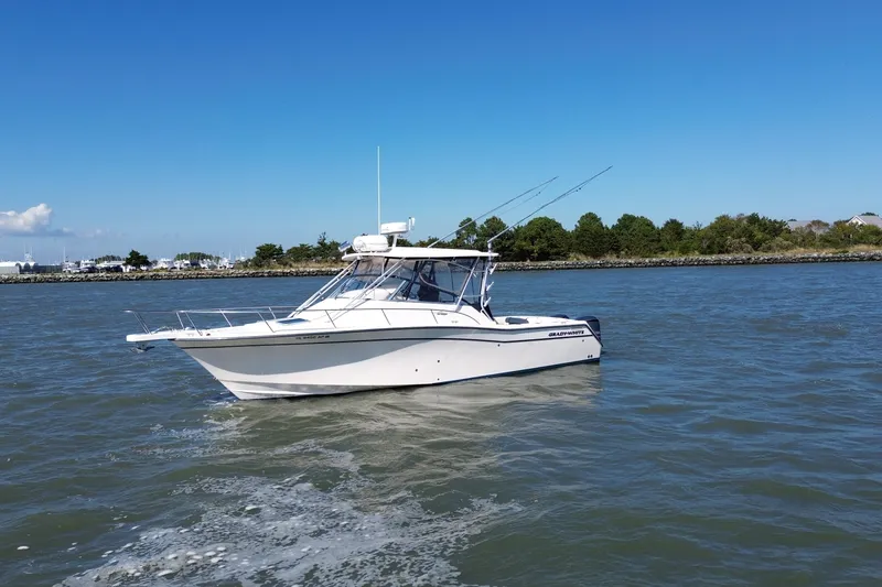 Slide: The Image of 2005 Grady-White Express 330 boat cruising on a sunny day near the shoreline. - 3