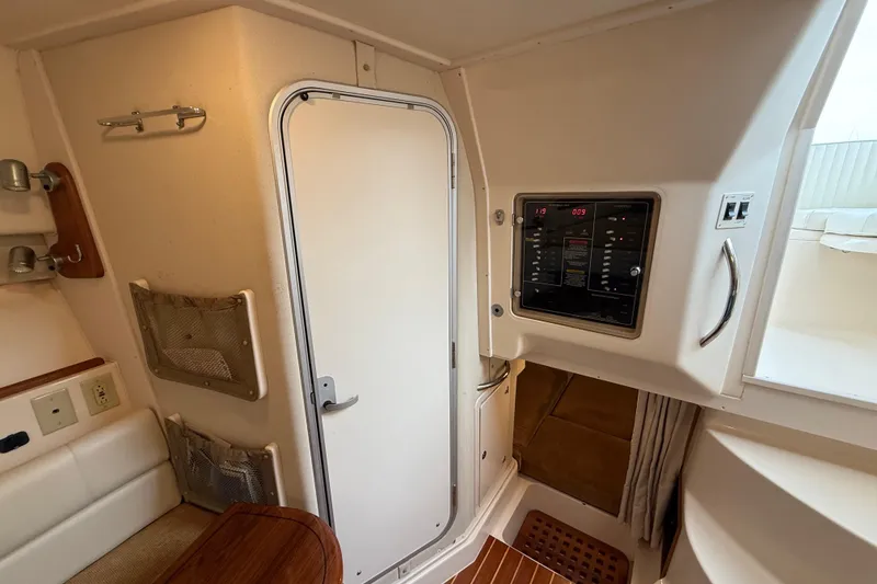 Slide: The Image of Interior of 2005 Grady-White Express 330 boat, featuring control panel and cabin door. - 30