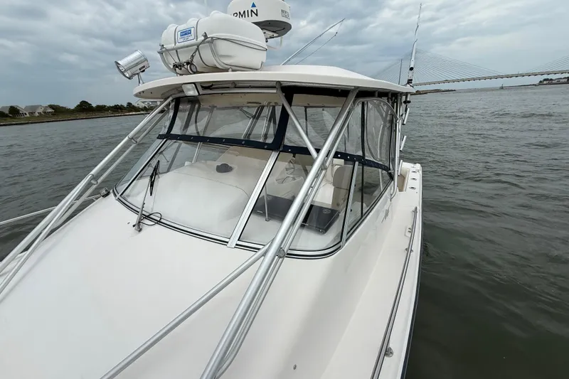 Slide: The Image of 2005 Grady-White Express 330 boat on water, featuring radar and fishing rods. - 39