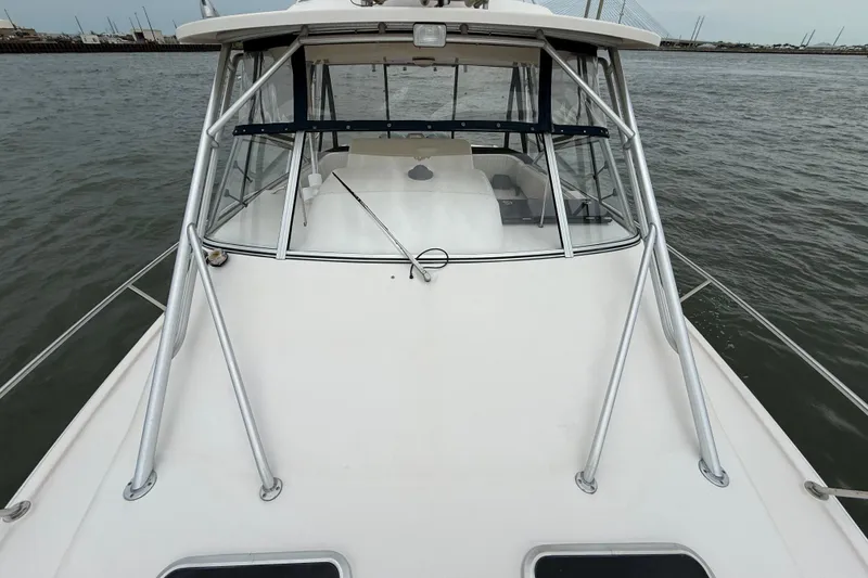 Slide: The Image of 2005 Grady-White Express 330 boat on water, front view with cabin and railing. - 41