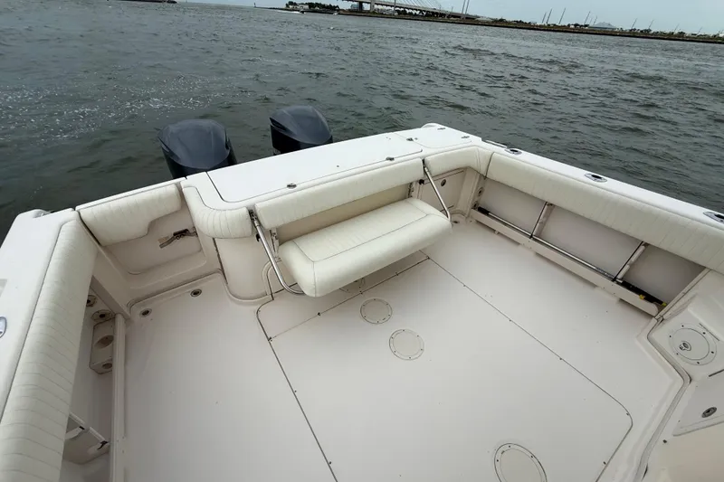 Slide: The Image of 2005 Grady-White Express 330 boat deck with seating, twin outboard motors, and ocean view. - 6