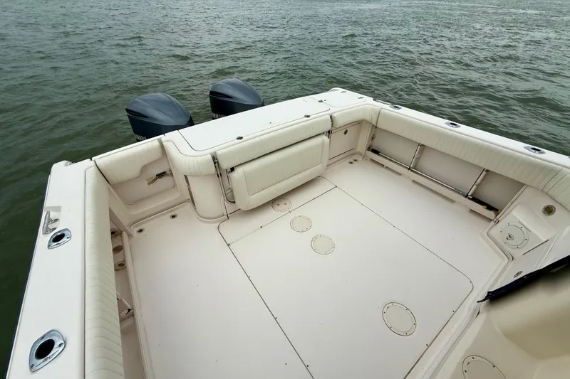 Slide: The Image of 2005 Grady-White Express 330 boat deck with twin outboard motors on water. - 7