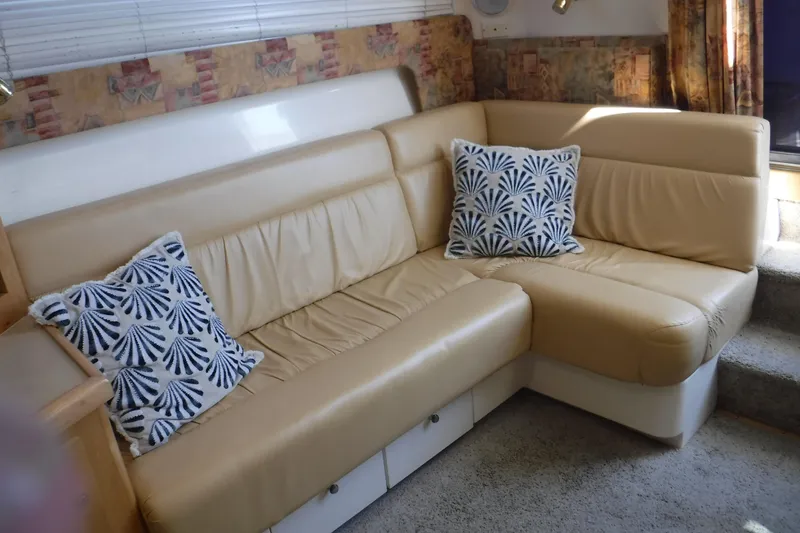 Slide: The Image of 2001 Carver 350 Mariner interior with beige leather sofa and decorative pillows. - 10