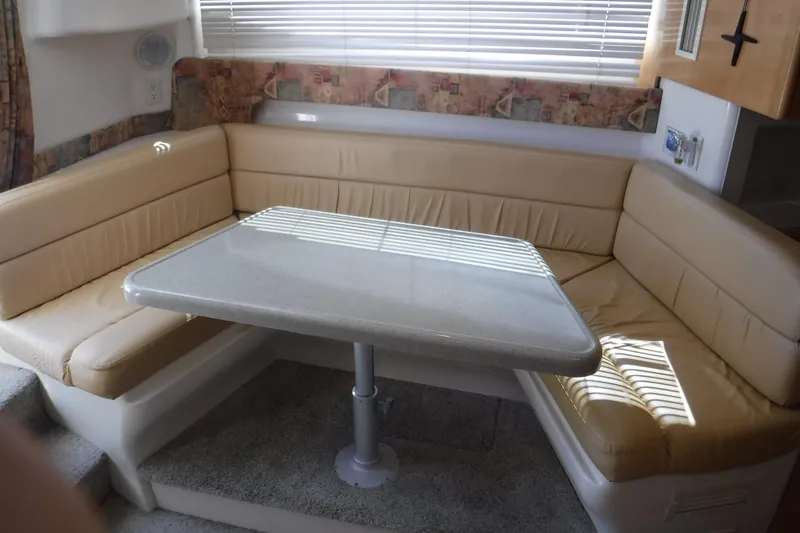 Slide: The Image of 2001 Carver 350 Mariner interior with beige leather seating and dining table. - 11