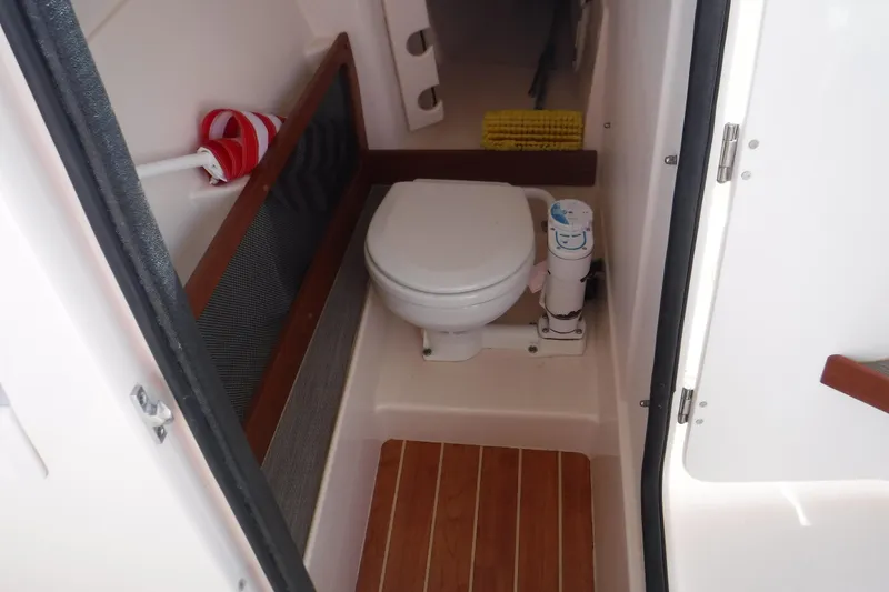 Slide: The Image of 2001 Carver 350 Mariner boat bathroom with toilet and wooden flooring. - 12