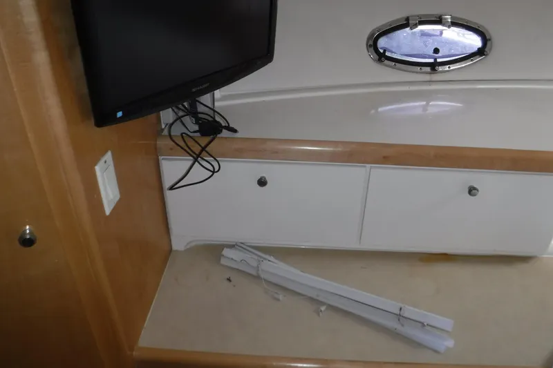 Slide: The Image of Interior of 2001 Carver 350 Mariner with TV, cabinets, and porthole window. - 15