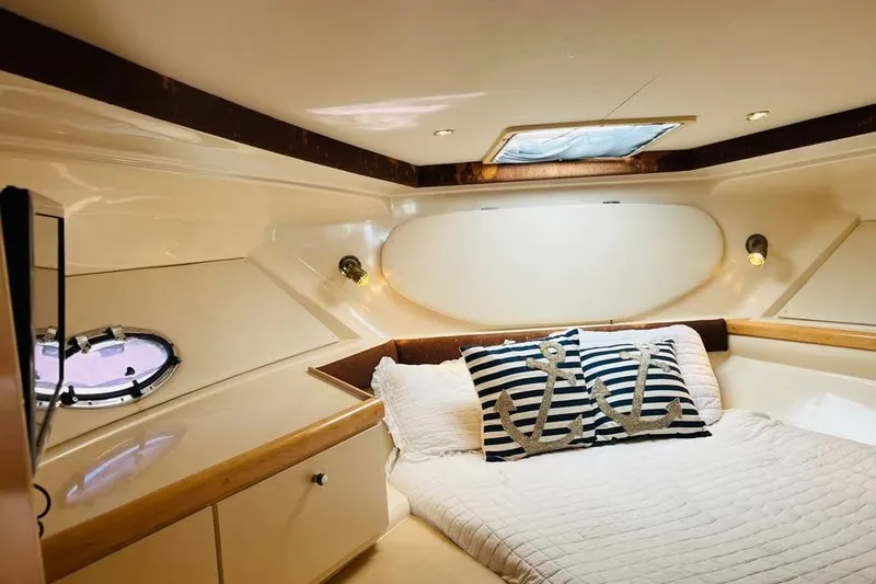 Slide: The Image of Cozy cabin interior of 2001 Carver 350 Mariner with nautical-themed pillows. - 16