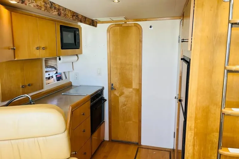 Slide: The Image of Interior of 2001 Carver 350 Mariner yacht with wood cabinetry and modern amenities. - 17