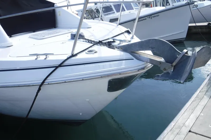 Slide: The Image of 2001 Carver 350 Mariner boat with anchor, docked at marina. - 2