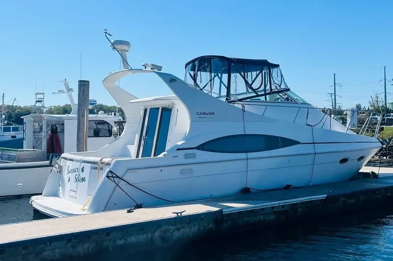 Slide: The Image of 2001 Carver 350 Mariner yacht docked at marina under clear blue sky. - 20