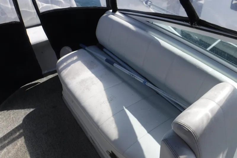 Slide: The Image of 2001 Carver 350 Mariner interior with white seating and boat equipment. - 3
