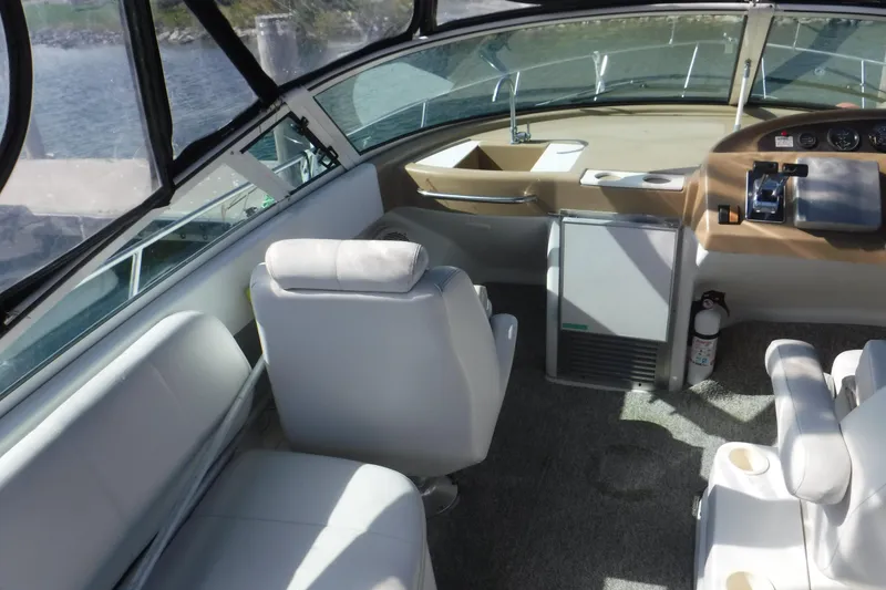 Slide: The Image of Interior of a 2001 Carver 350 Mariner boat, featuring helm and seating area. - 4