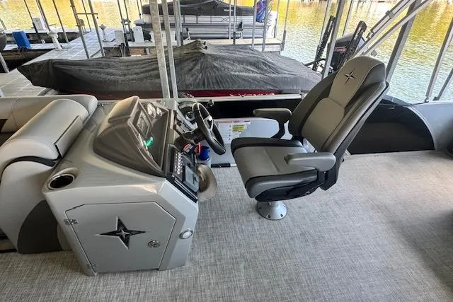 Slide: The Image of 2022 Berkshire 250CL STS boat interior with captain's chair and control panel. - 10