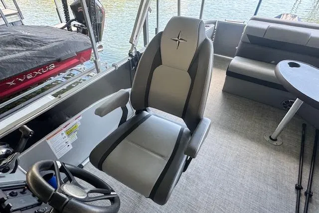Slide: The Image of 2022 Berkshire 250CL STS boat interior with captain's chair and seating area. - 13