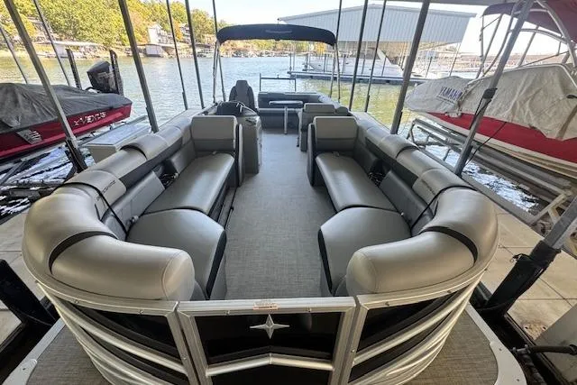 Slide: The Image of 2022 Berkshire 250CL STS pontoon boat with spacious seating, docked at a marina. - 17