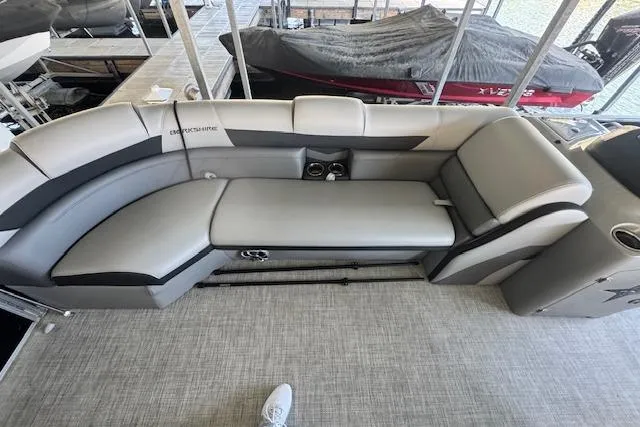Slide: The Image of 2022 Berkshire 250CL STS boat interior with gray seating and cup holders. - 21
