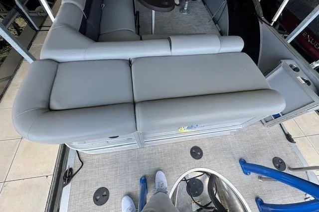 Slide: The Image of 2022 Berkshire 250CL STS pontoon boat interior with gray seating and deck view. - 23