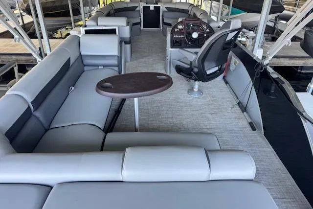 Slide: The Image of 2022 Berkshire 250CL STS pontoon boat interior with gray seating and steering console. - 24