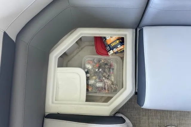 Slide: The Image of Storage compartment in a 2022 Berkshire 250CL STS boat with assorted items inside. - 31