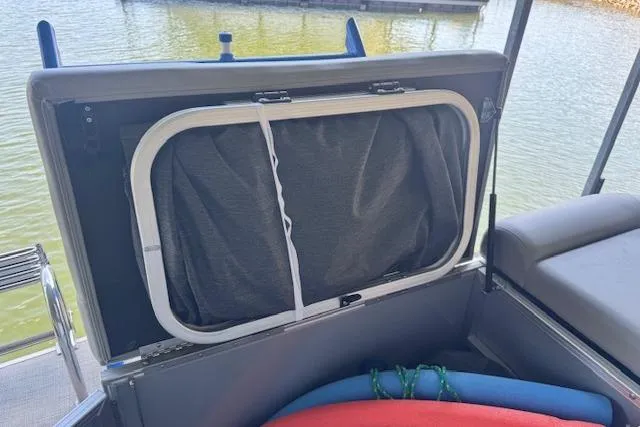 Slide: The Image of 2022 Berkshire 250CL STS boat interior storage compartment with water view. - 32