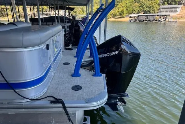 Slide: The Image of 2022 Berkshire 250CL STS pontoon boat with Mercury engine docked on a lake. - 35